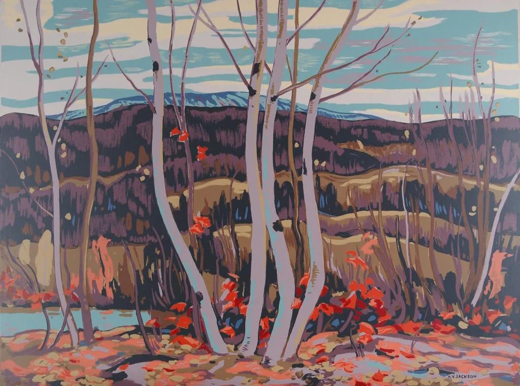 An autumn landscape featuring leafless trees with thin trunks, a water body, and distant rolling hills with sparse vegetation. The sky is cloudy with streaks of light blue and gray.