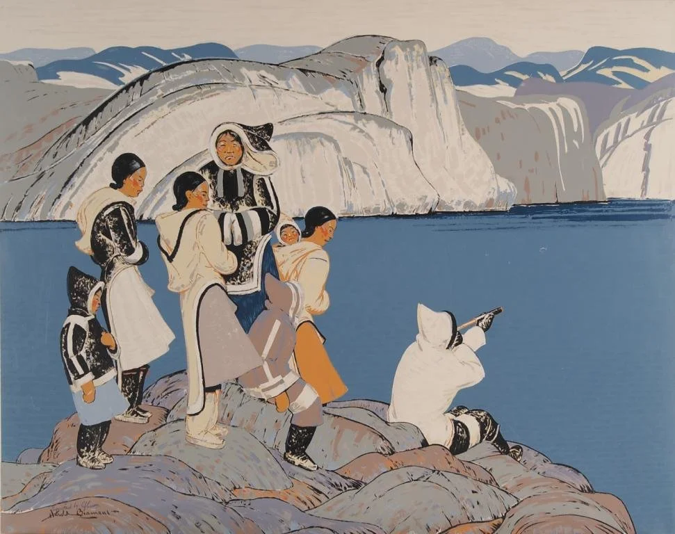 A group of Native American women and children standing on rocks by a lake, with cliffs and mountains in the background. One woman is sitting and pointing out towards the lake.