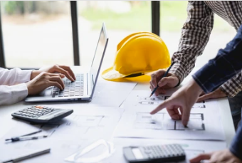 Construction and client project team meeting - meet and greet where reviewing blueprints at a collaborative workspace.