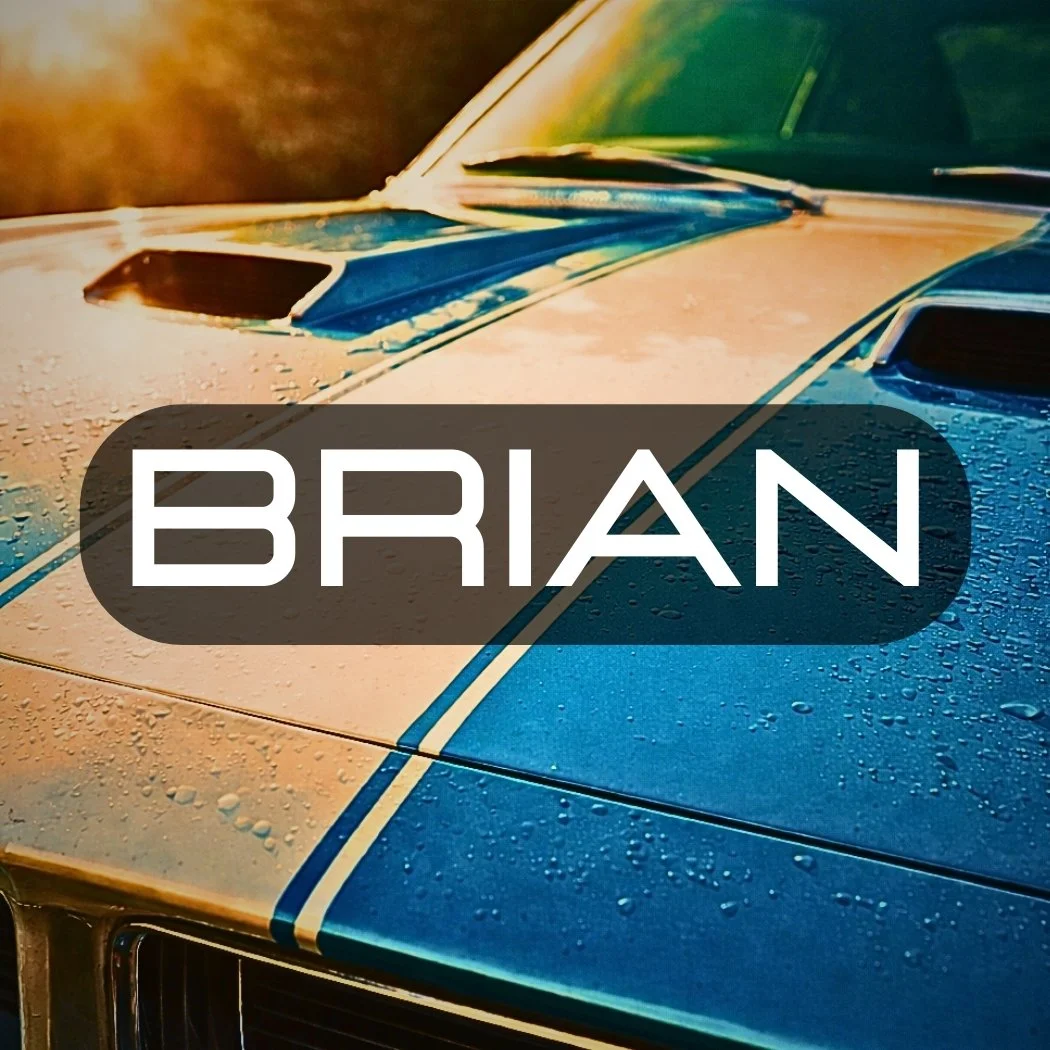 Photo of a blue vintage car with white letters on top saying "BRIAN"