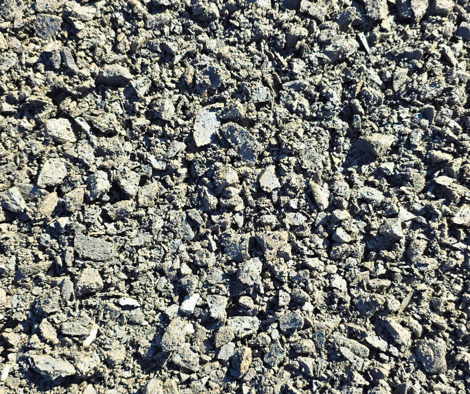 Close-up of gray loose gravel and small rocks on the ground also called minus rock, can be purchased from Haley's Heritage quarry in Sweet Home, Oregon