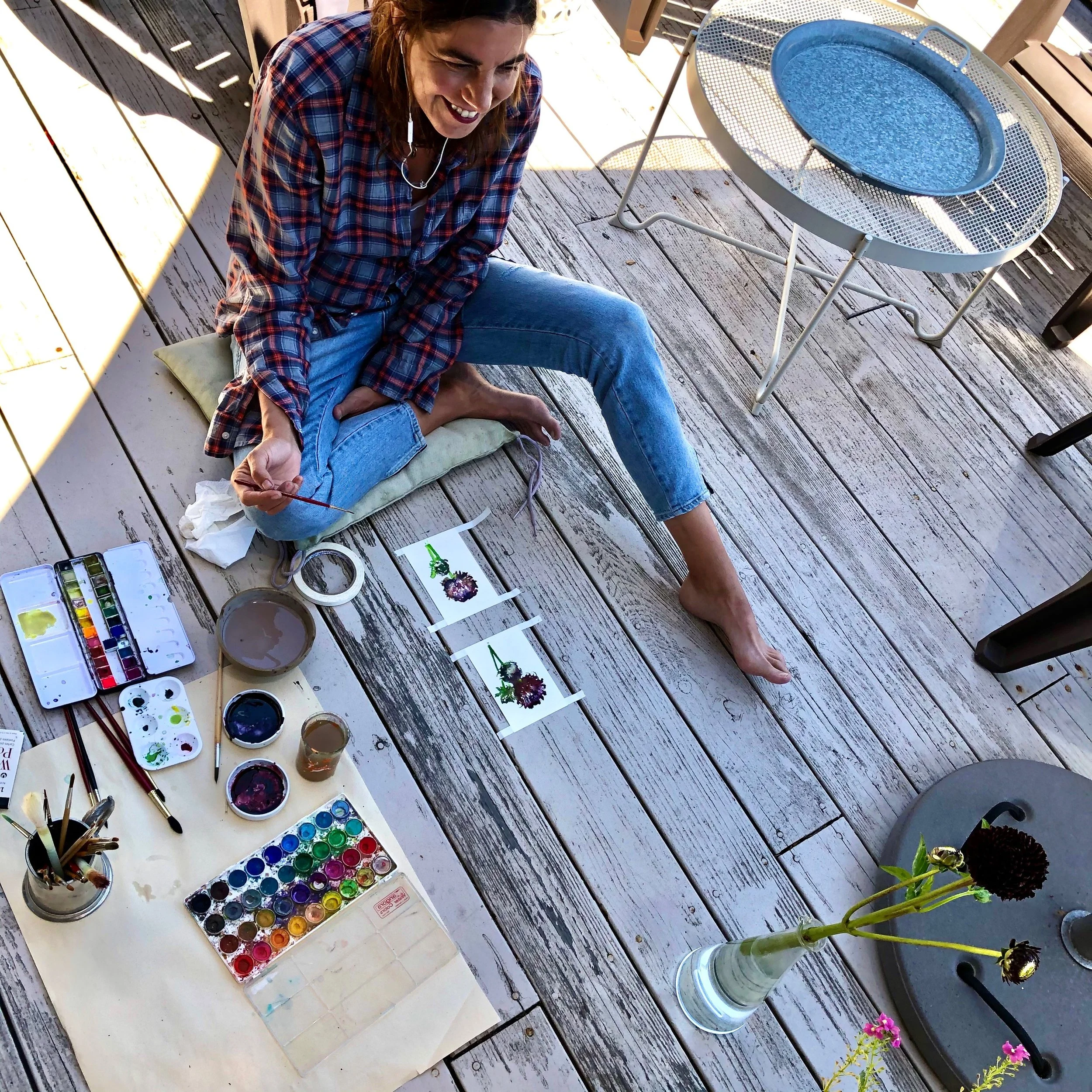 Jennifer Mobley, watercolor botanical illustrations with paints and brushes outdoors.