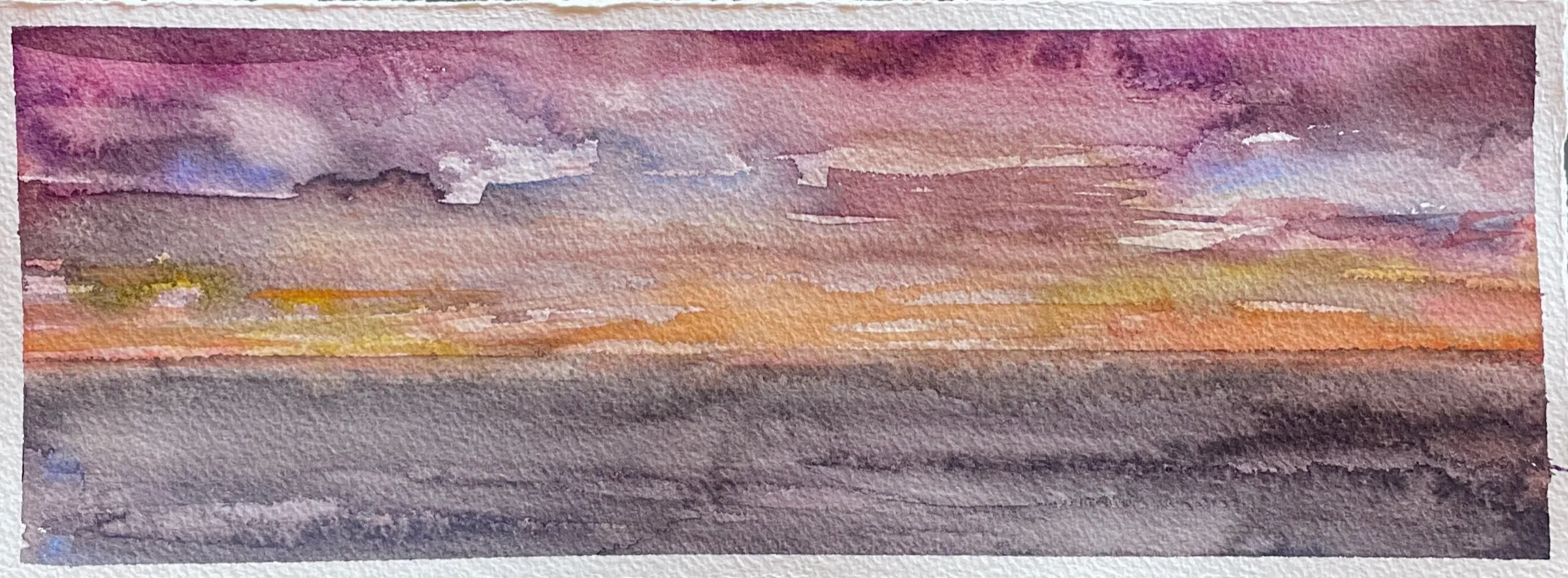 Watercolor painting of a sunset over the ocean with a colorful sky of pink, purple, orange, and yellow tones.