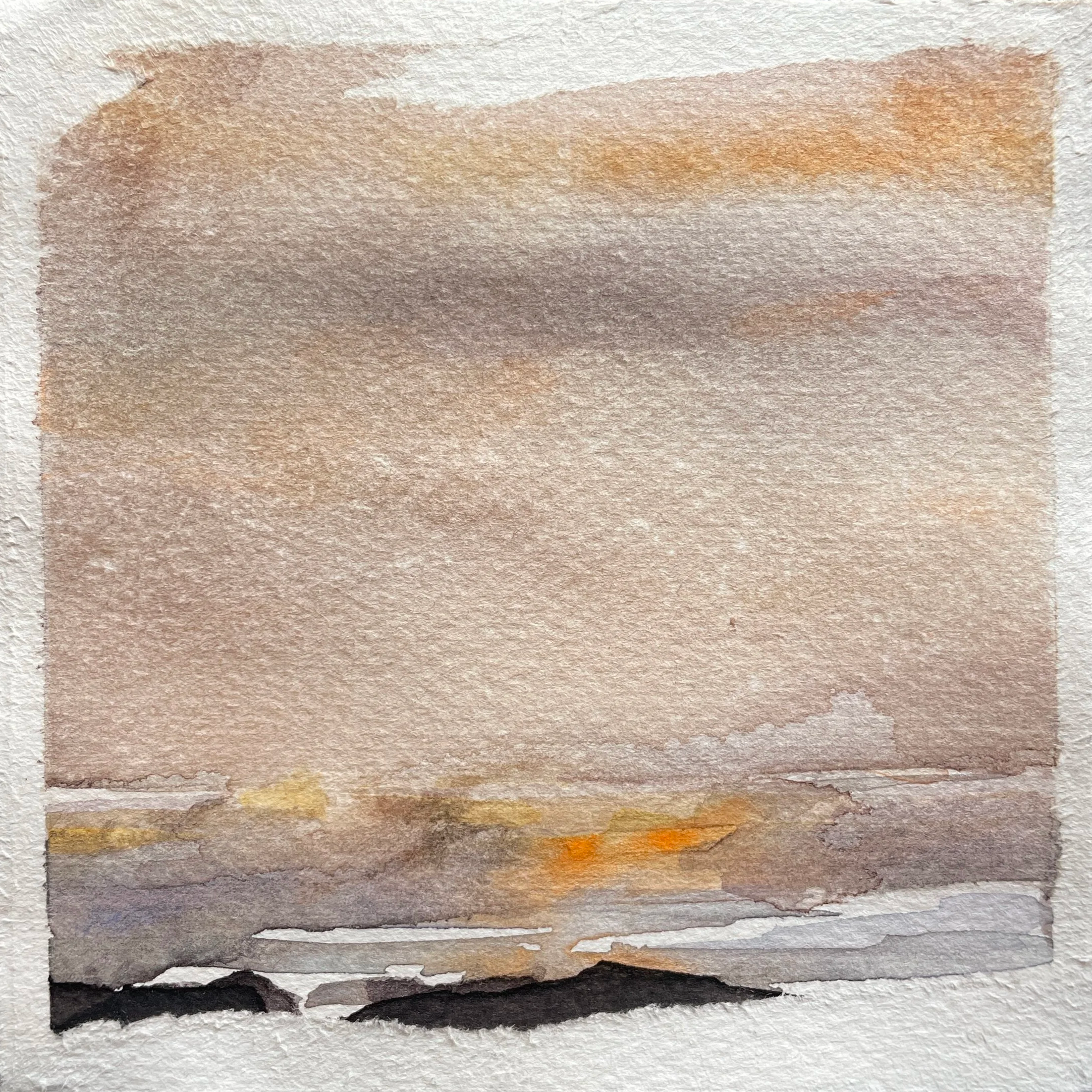 Watercolor painting of a sunset over a body of water, with clouds in the sky and dark rocks at the shoreline.
