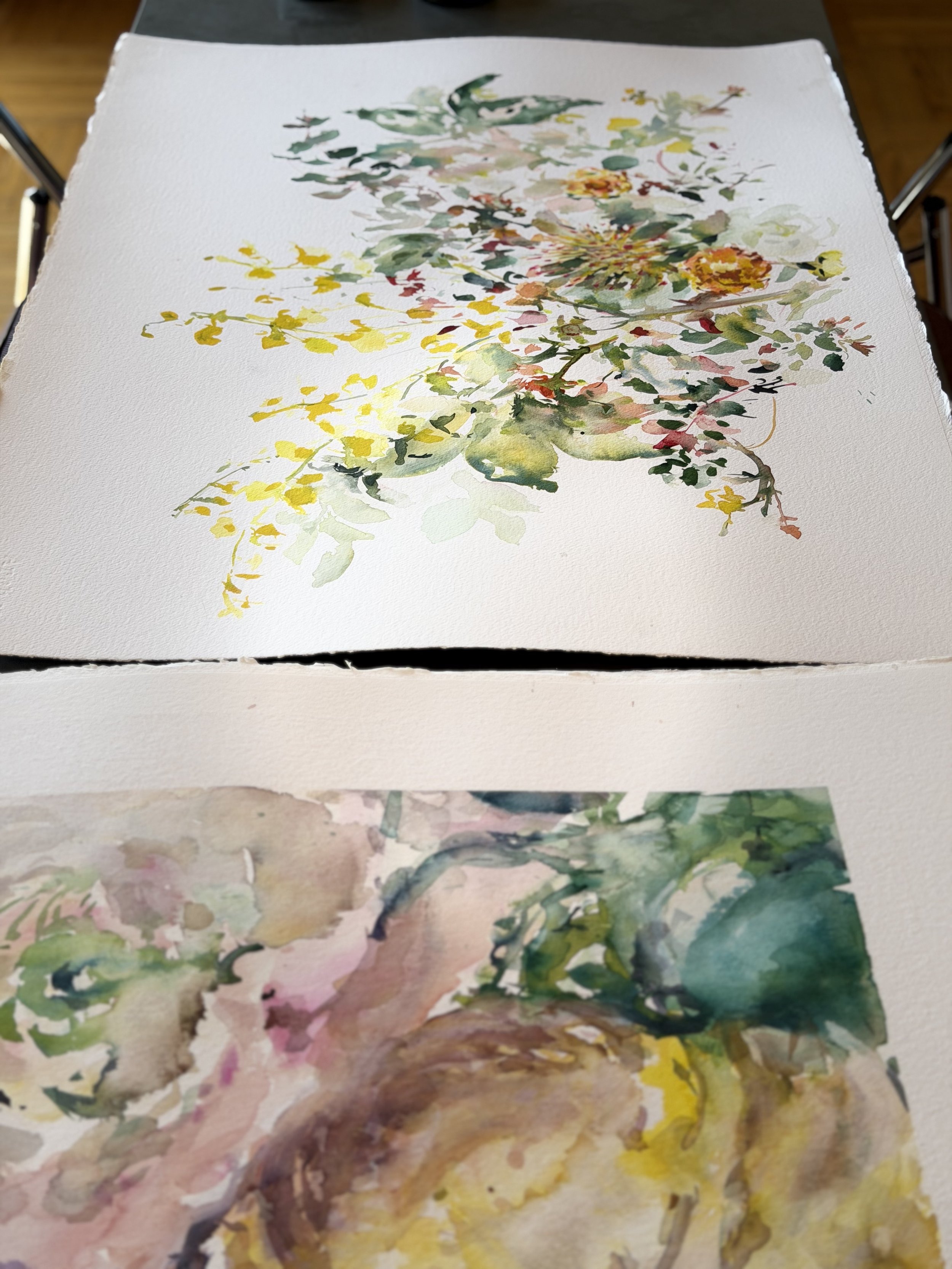 Watercolor paintings of floral arrangements on a white textured surface, with one painting showing a bouquet of pink, yellow, and green flowers and the other depicting a face with floral details.