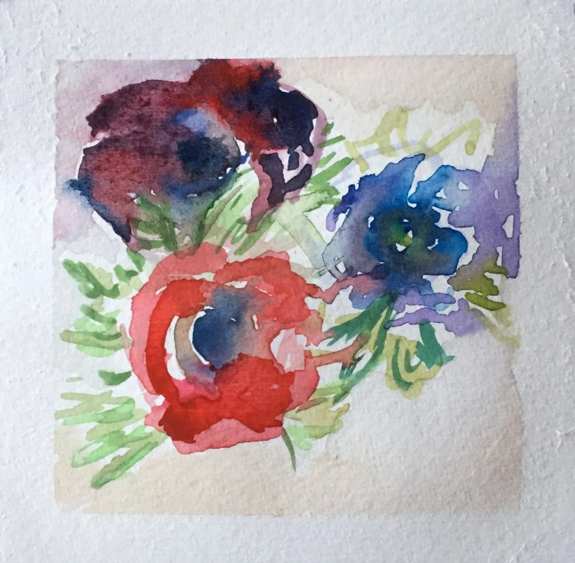 Watercolor painting of a bouquet of red, purple, and blue flowers with green leaves on watercolor paper.