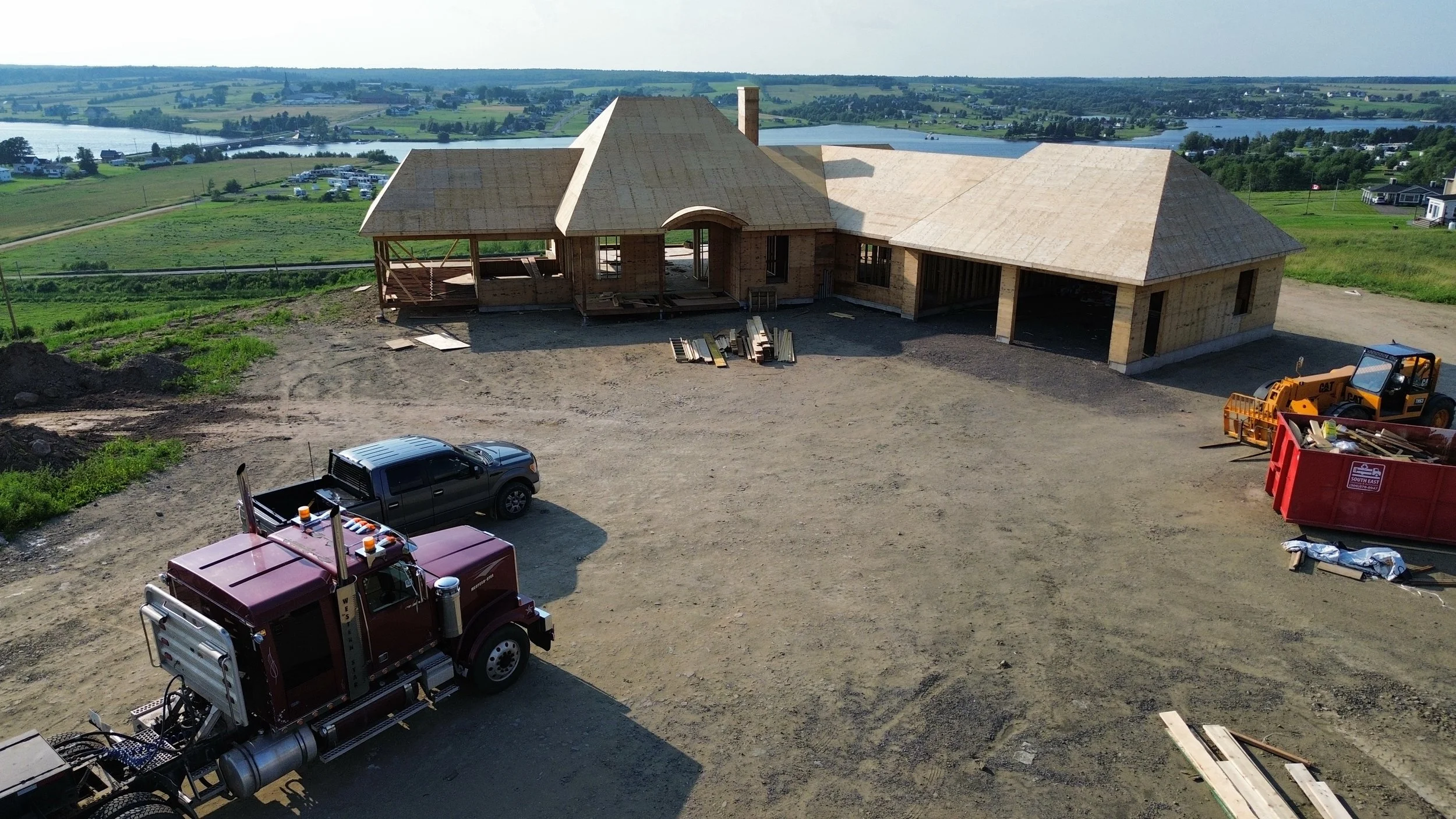 Custom home framing under construction overlooking a Saskatchewan lake, built by LSR Contracting