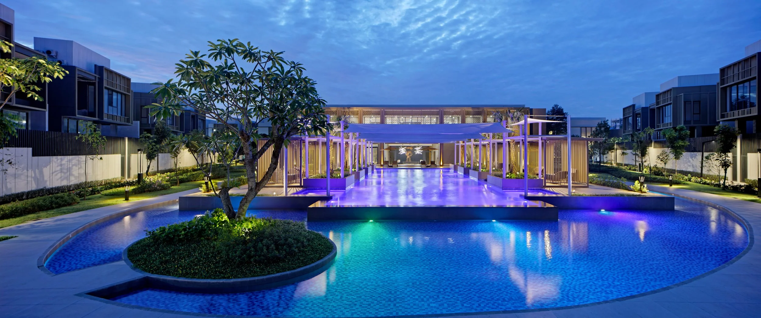 Enchante Club House evening poolside view overlooking the illuminated clubhouse