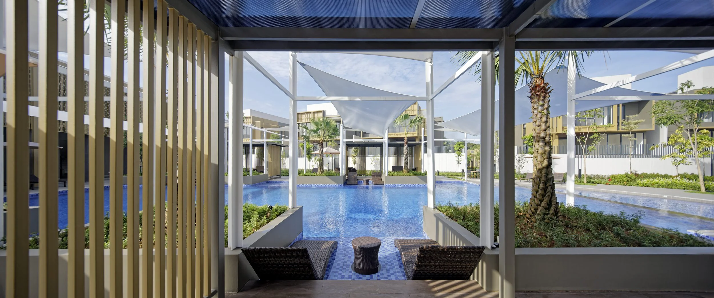 Enchante Club House swimming pool viewed from the poolside seating area