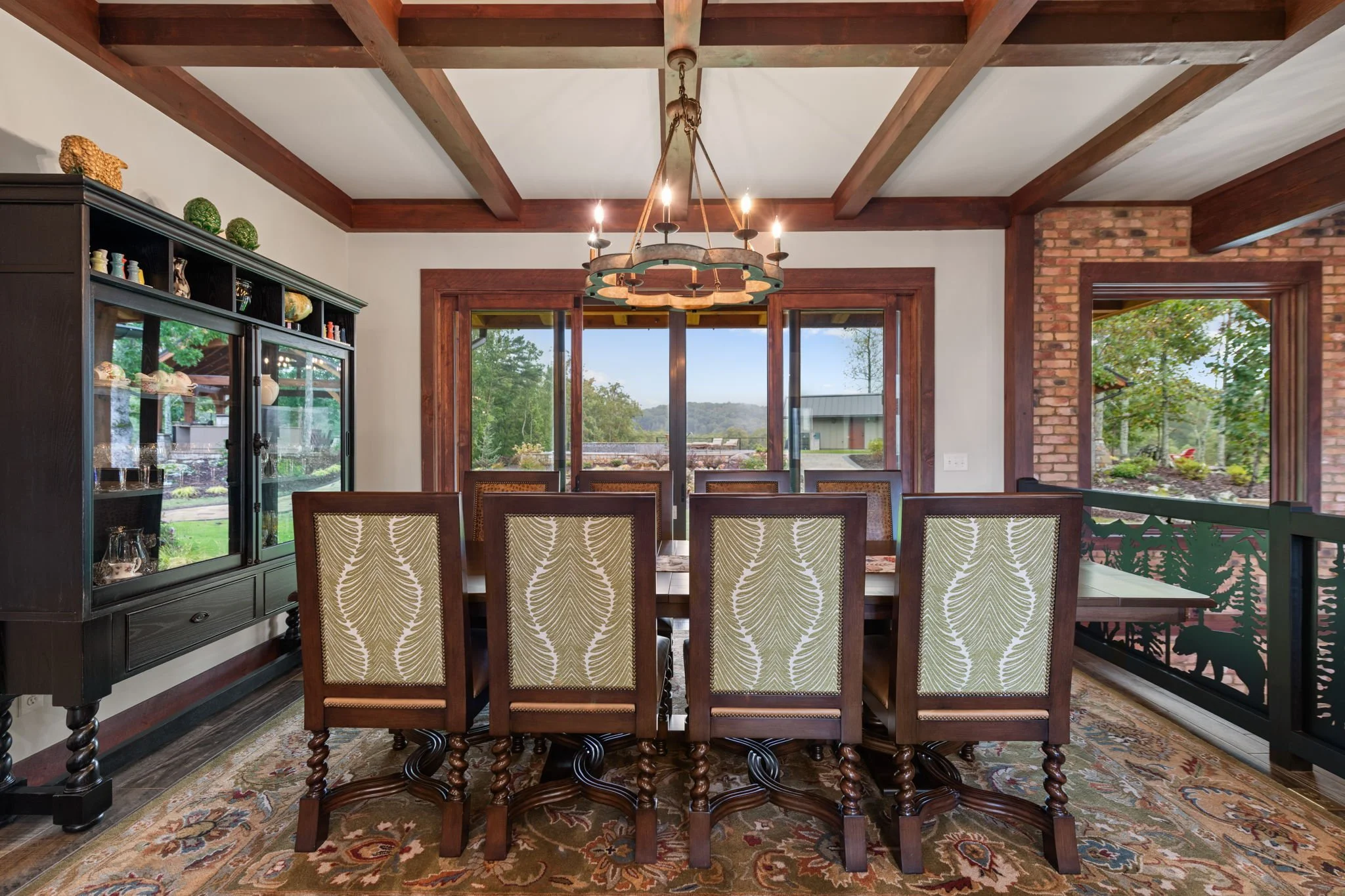 Custom mountain home living space with expansive windows and natural materials designed for North Georgia views