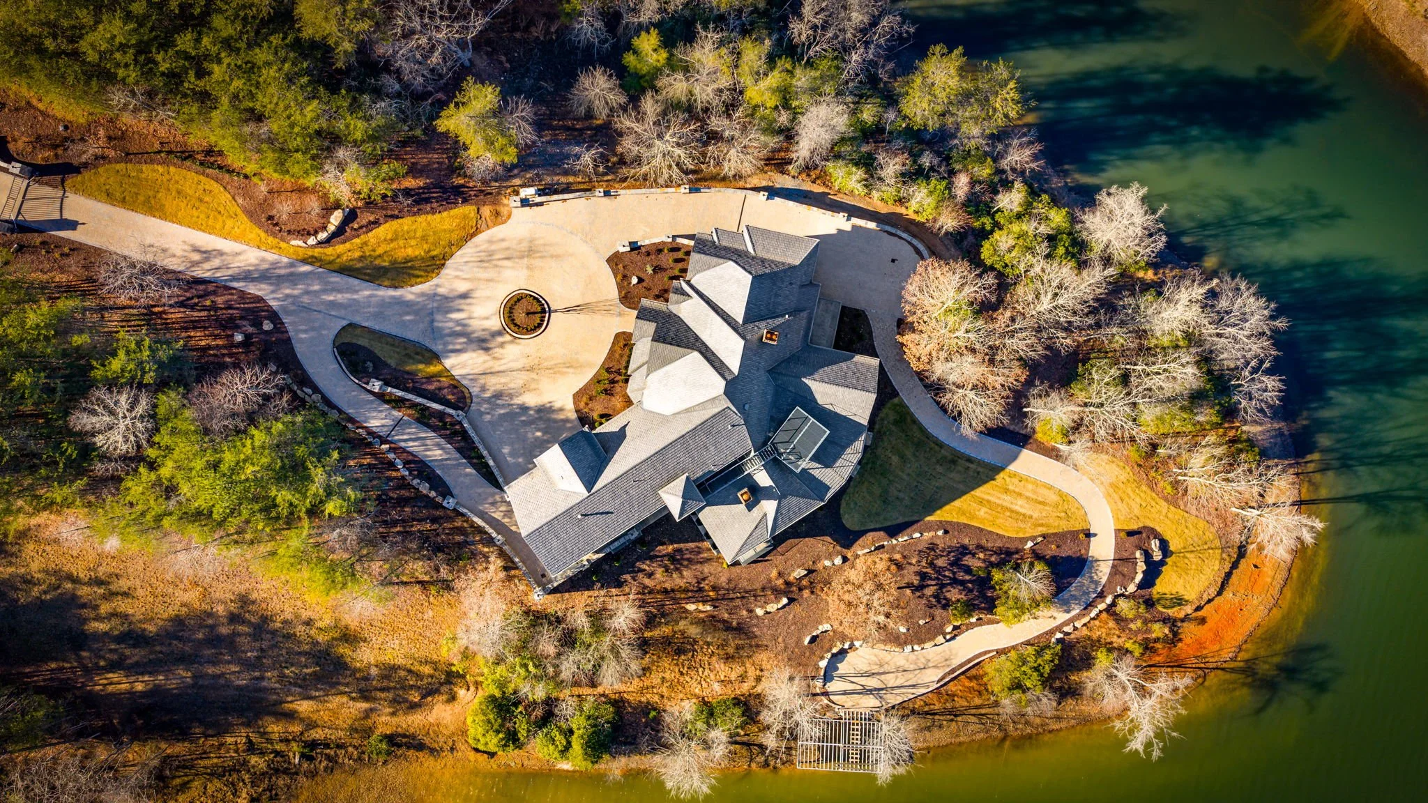 Lake front property with cobblestone driveway with old-world atmosphere and archways on a point, waterfront