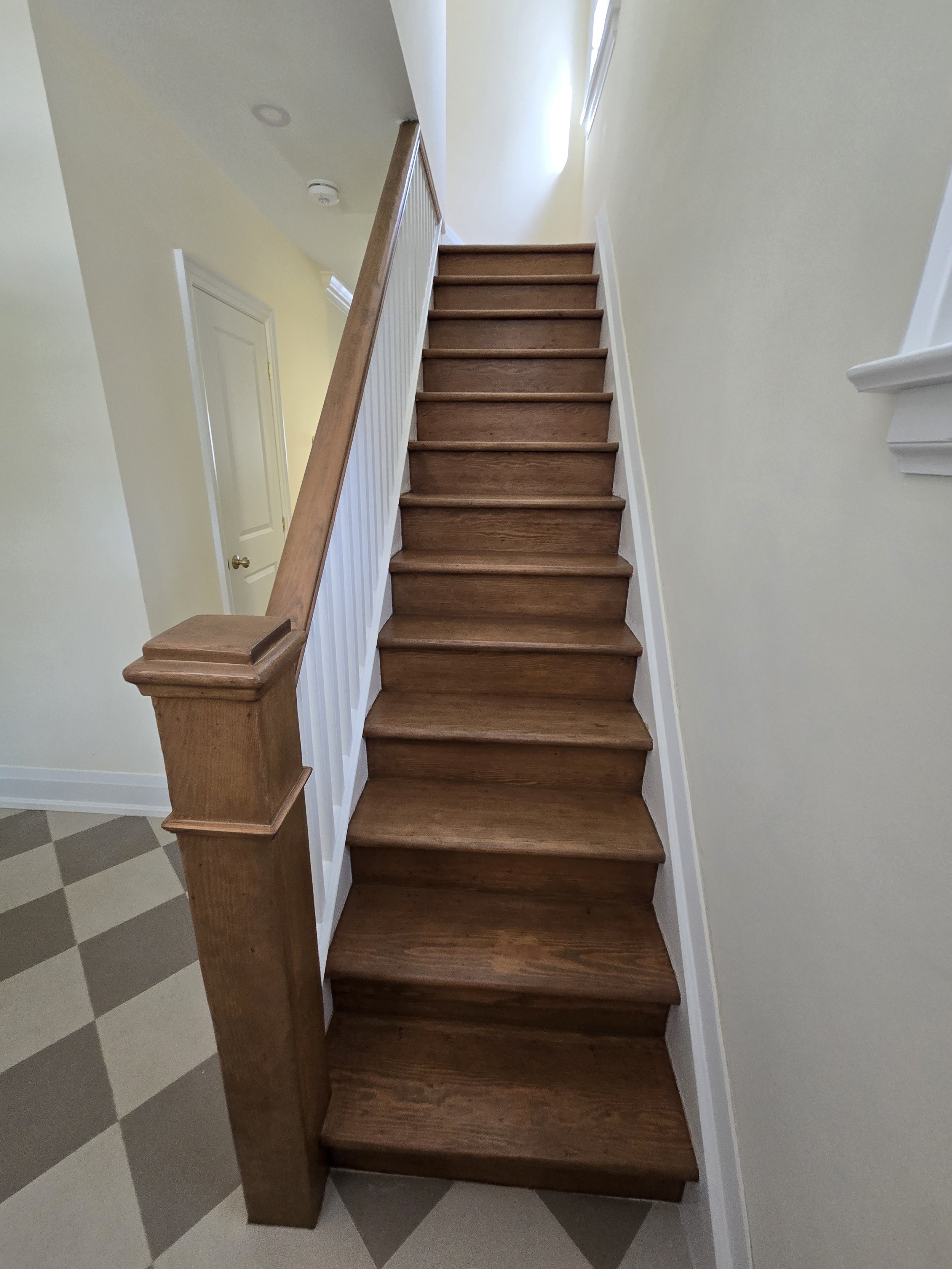 Century stairs after: Stairs lightened to match upper hardwood and custom stain and topcoat added.
