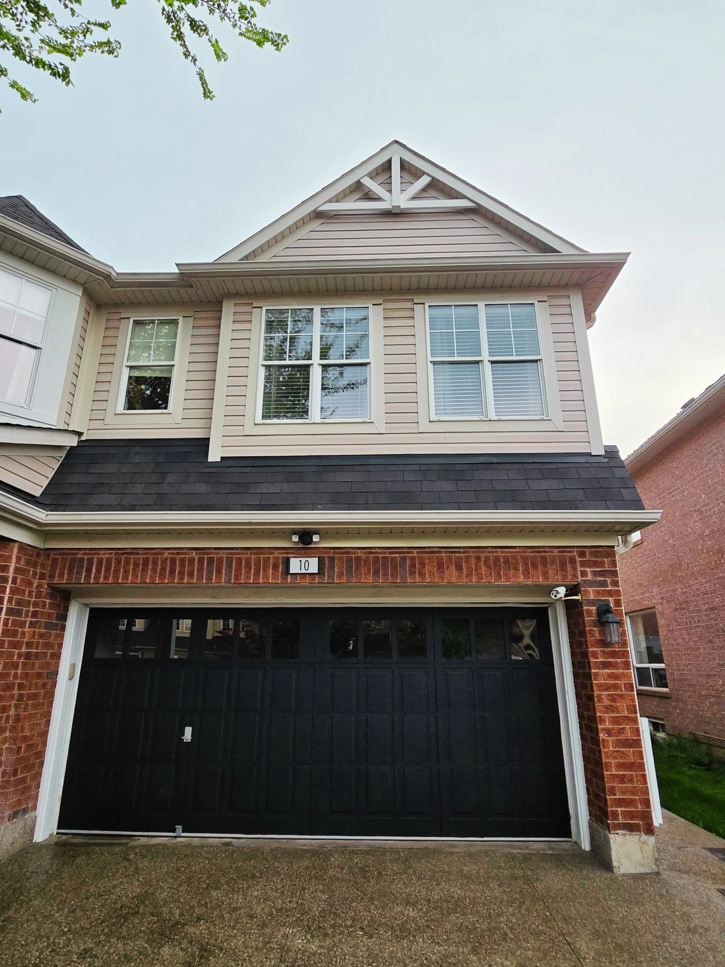 Dehavilland After - Pressure wash, scaraping and priming ahead of fresh paint on wood accents and garage door.  Wood accents BM Glacier White (HC-103) & garage door BM Black Satin (2131-10)