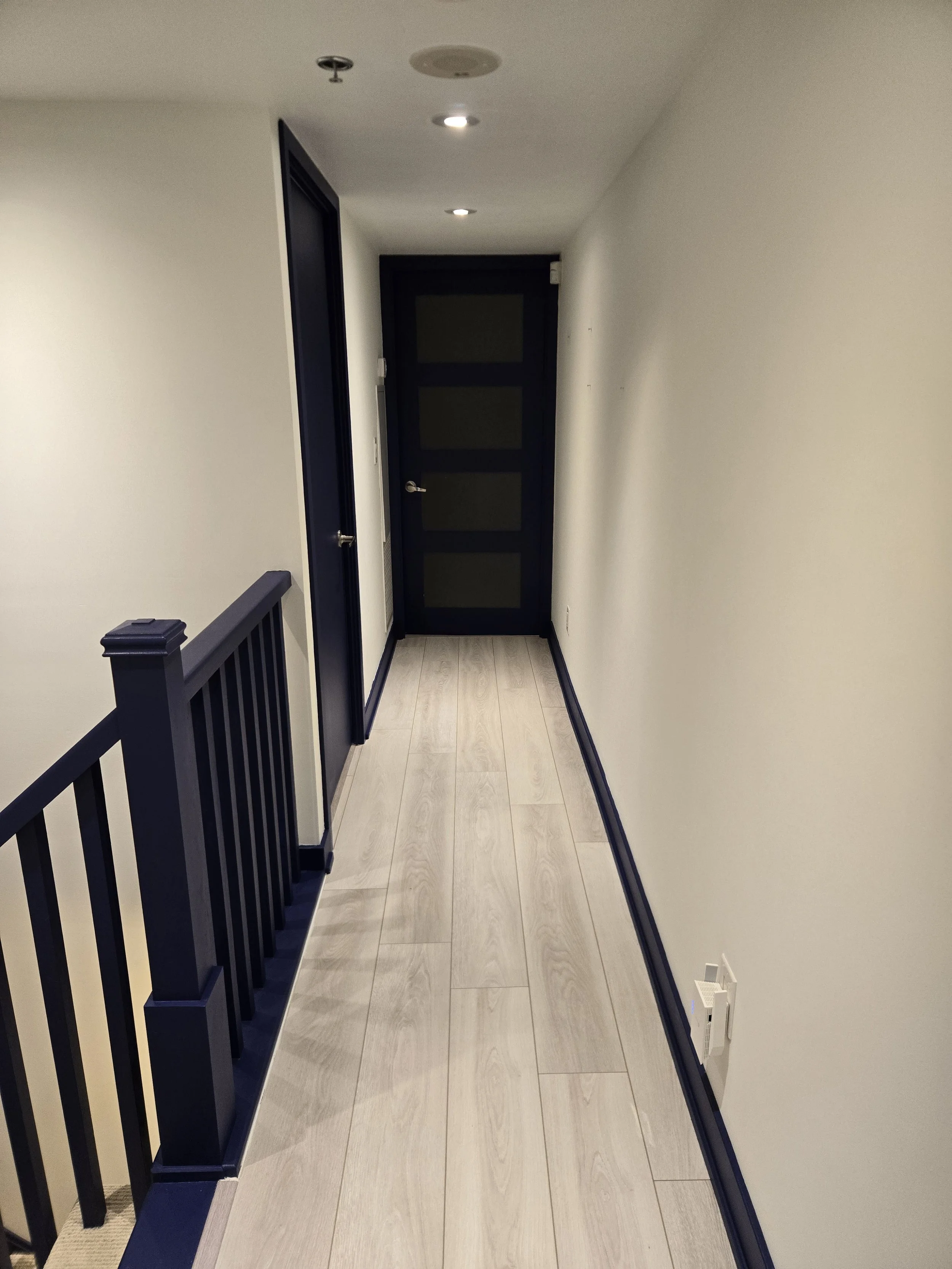 Mimico Townhouse - Post Work.  Strong definition with refreshing the walls (BM Snowfall White OC-148) and adding colour and definition to the trim & doors (BM Blue Grotto CC-964)