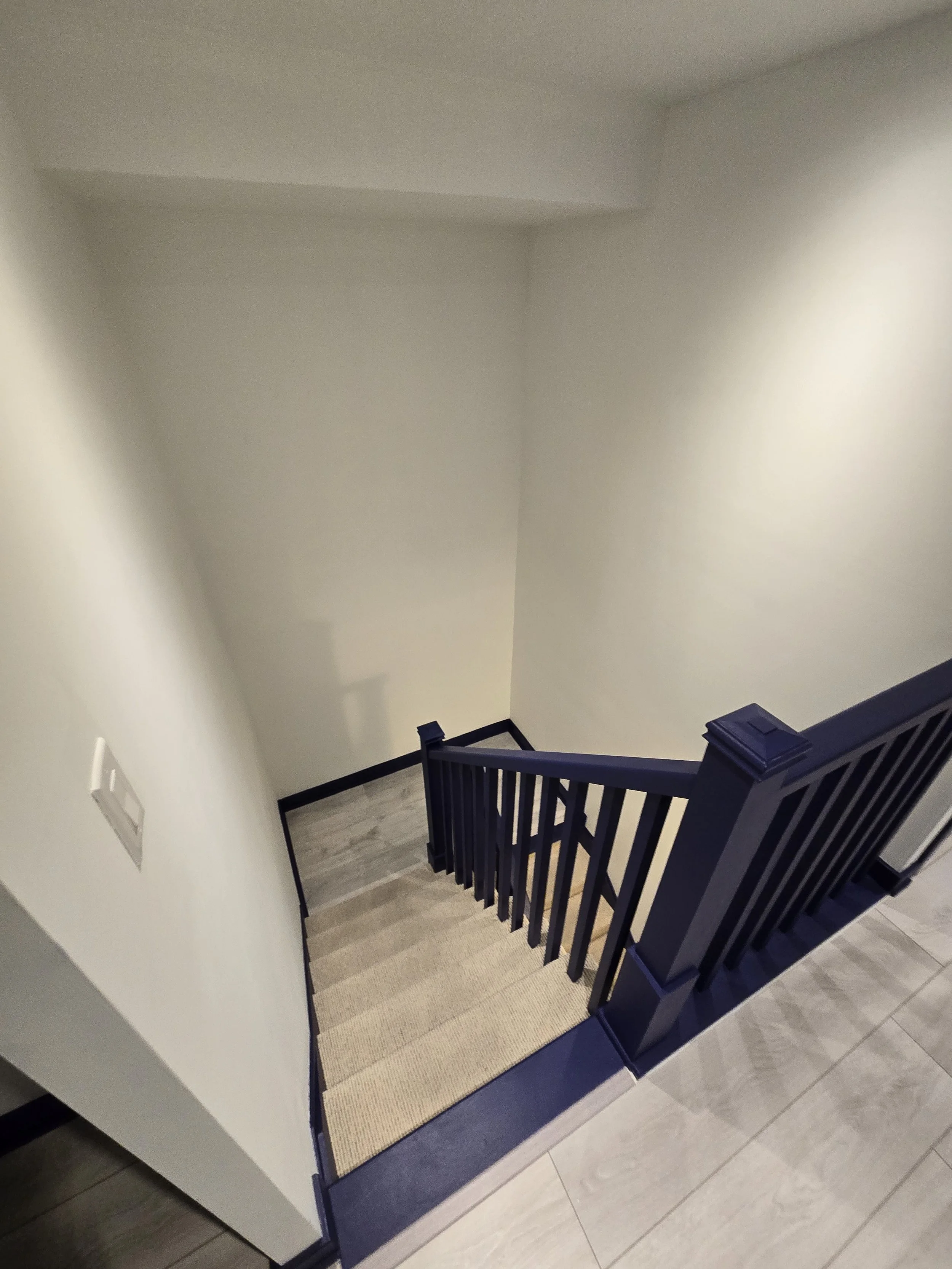 Mimico Townhouse Post Work.  Strong definition added with refreshed walls (BM Snowfall White CC-148) and striking blue trim and handrail (BM Blue Grotto CC-964)