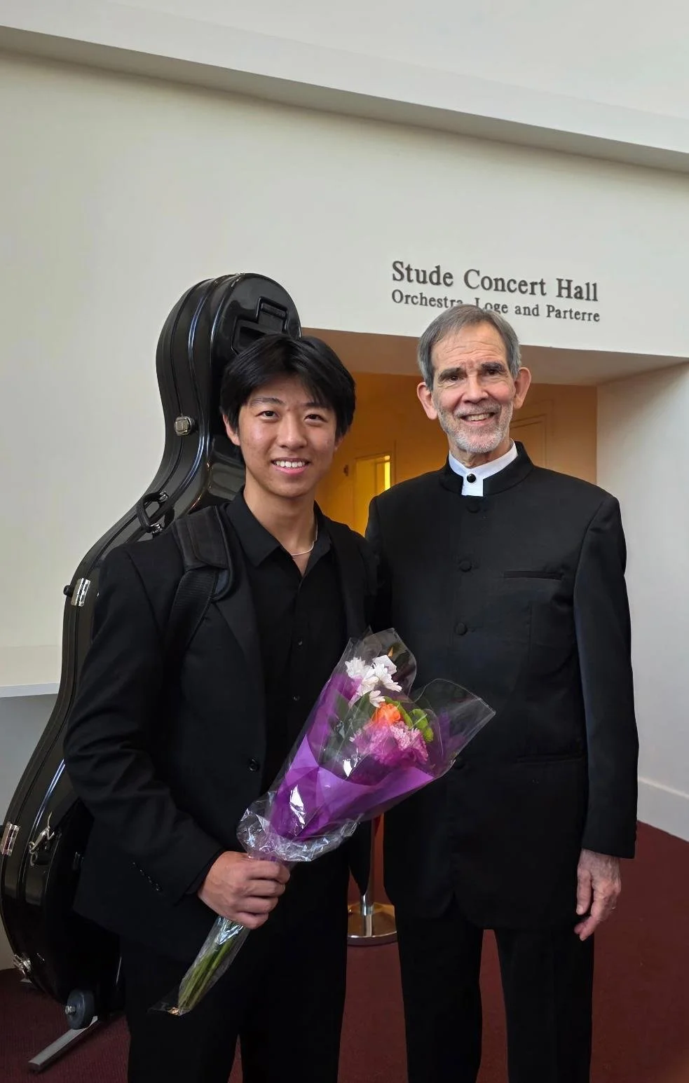 Andy Wu standing next to a professionally dressed man