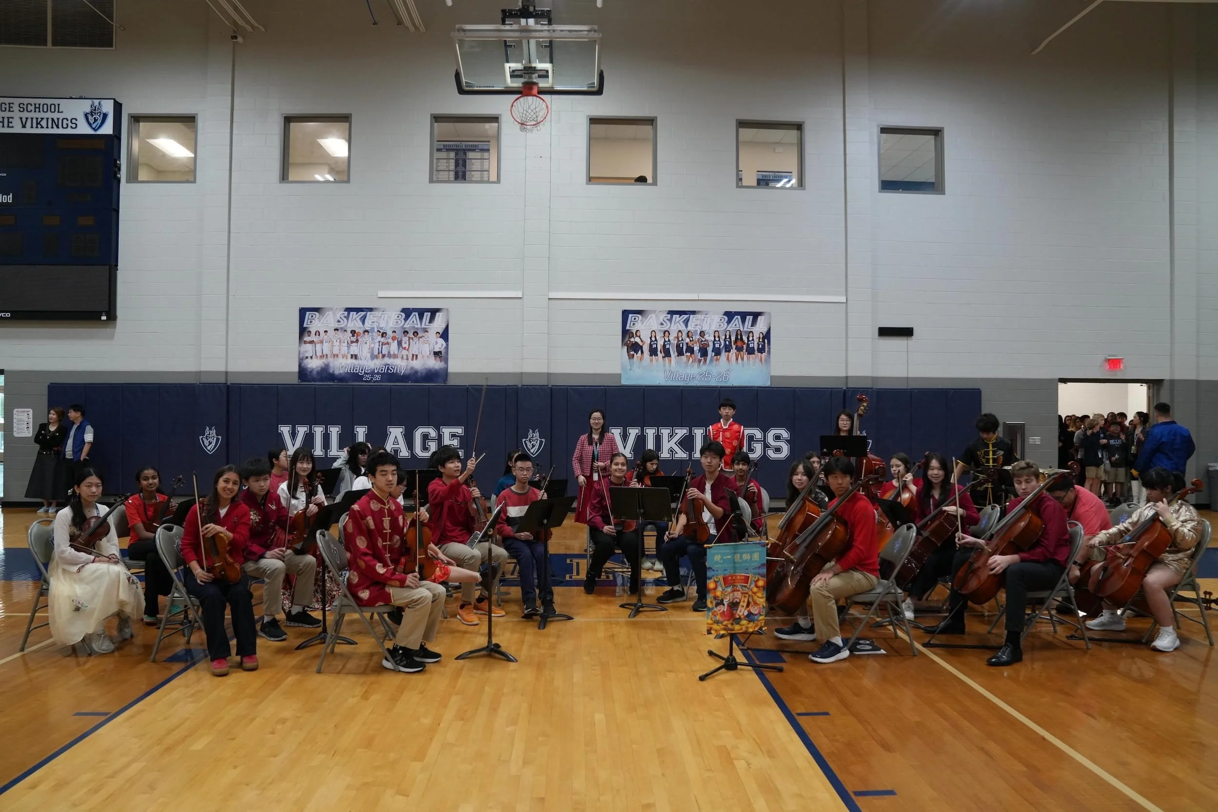 Chamber orchestra performing holiday concert for community audience in modern venue