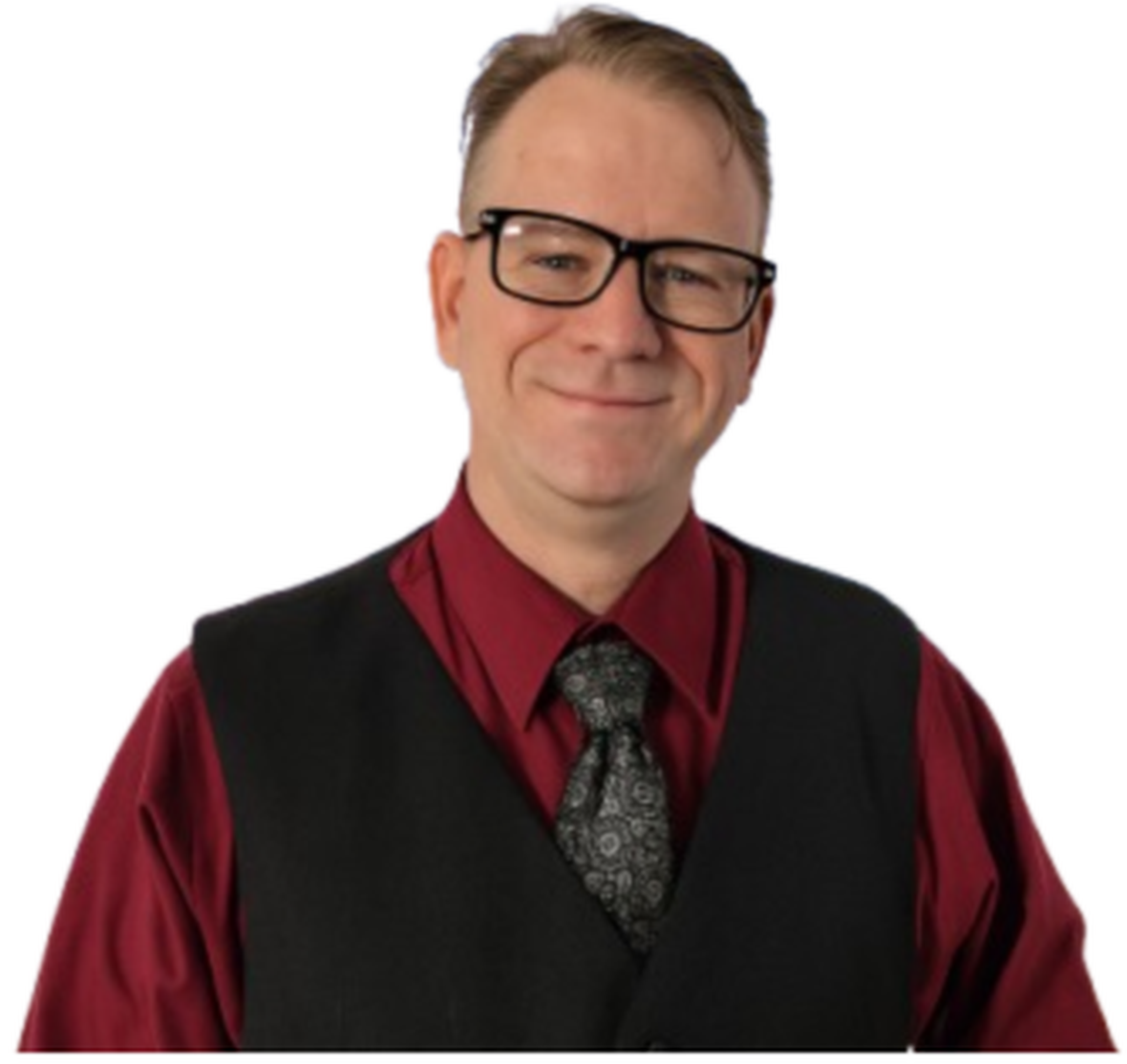 Portrait of a middle-aged man with glasses, wearing a red shirt, black vest, and patterned tie, smiling against a plain white background.