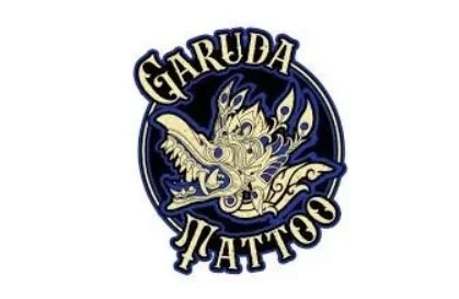A logo for Garuda Tattoo featuring a mythical creature with wings, holding a sword, and stylized text.