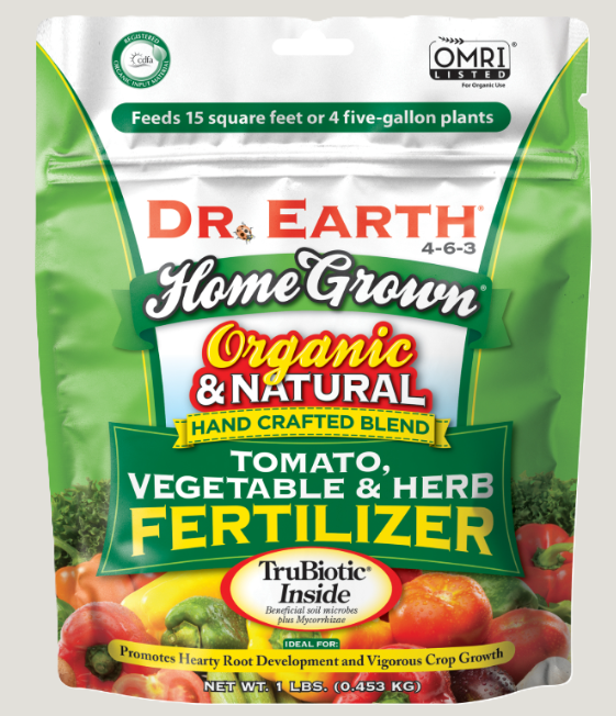 Green bag of Dr. Earth Organic & Natural Tomato, Vegetable & Herb Fertilizer with images of vegetables and herbs on the packaging.