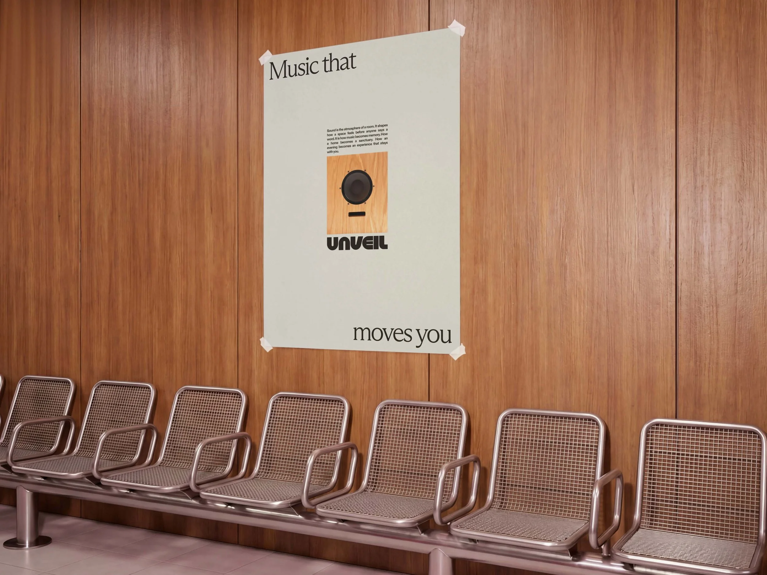 Empty waiting area with a row of metal chairs against a wood-paneled wall and a poster about music that says 'Music that moves you.'