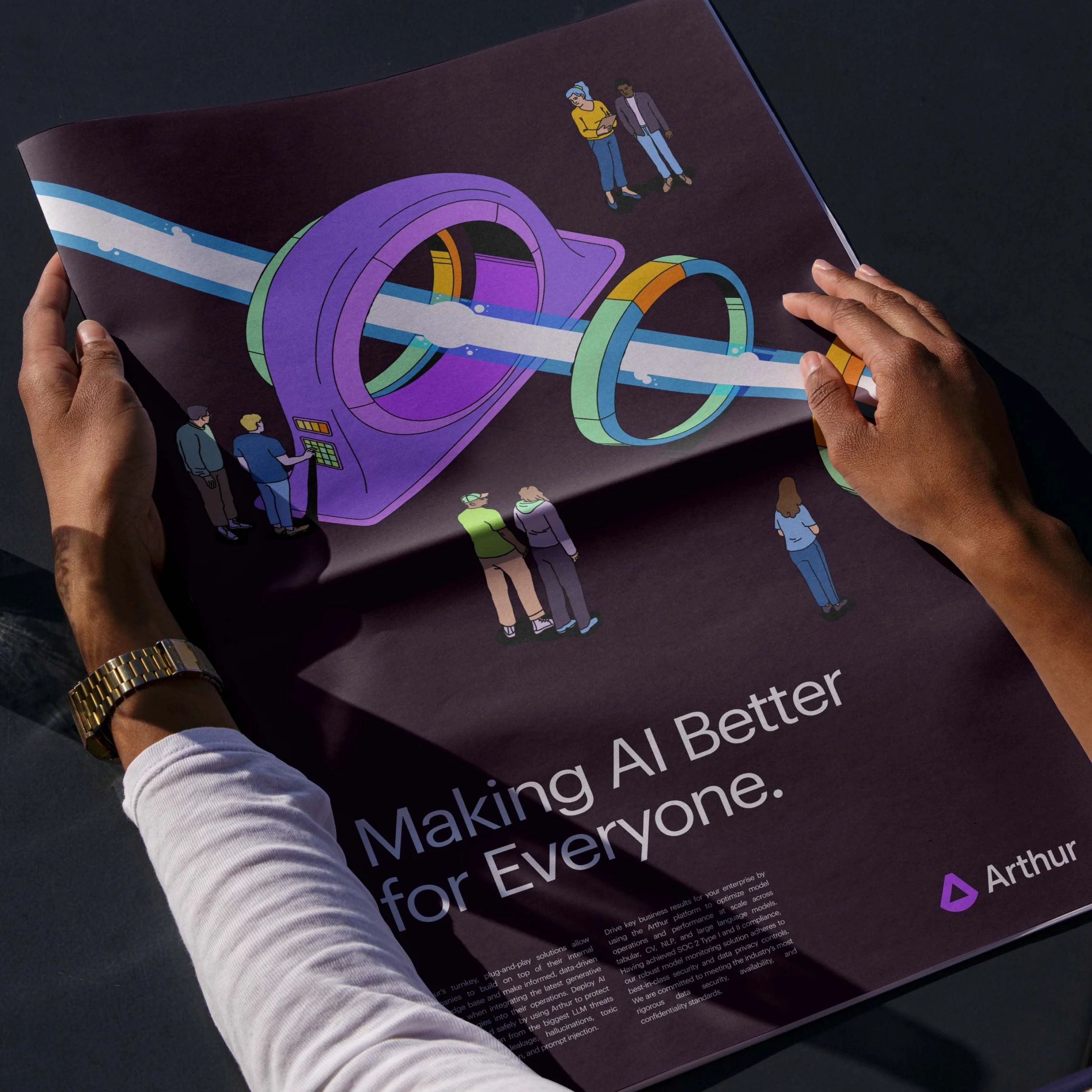 Hands holding a brochure with colorful illustrations and scientific imagery, featuring people and text.