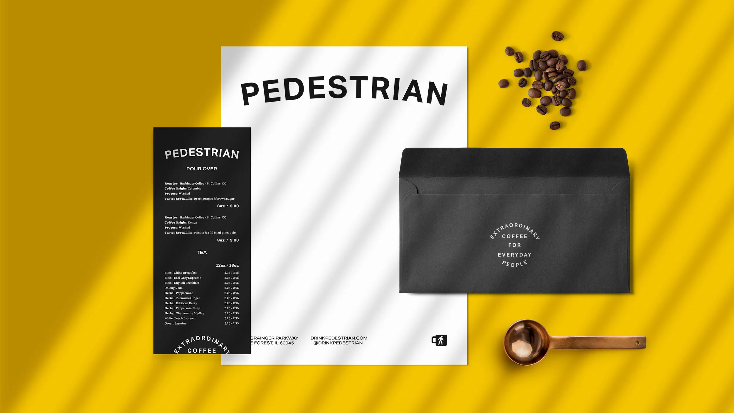 Coffee shop menu with black and white sections on a yellow background, coffee beans scattered, black paper bag with white text, small copper measuring scoop.