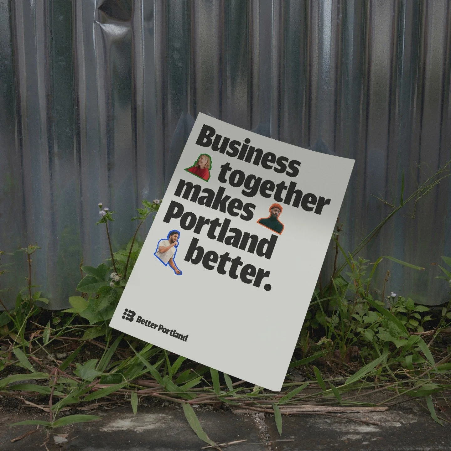 A political sign with the text "Business together makes Portland better" and images of three people, one woman with green hair, one man with a beard, and one man with dark hair, set against a background of green plants and a metal fence.