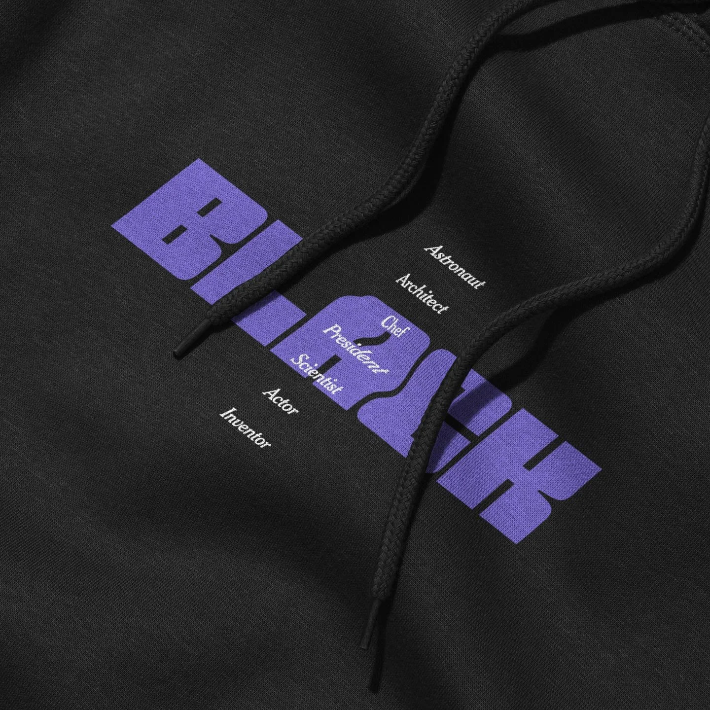 Black hoodie with NASA-themed graphic in purple and white text and icons, including words like 'Astronaut,' 'Architect,' and 'Scientist,' along with a stylized mountain range graphic.