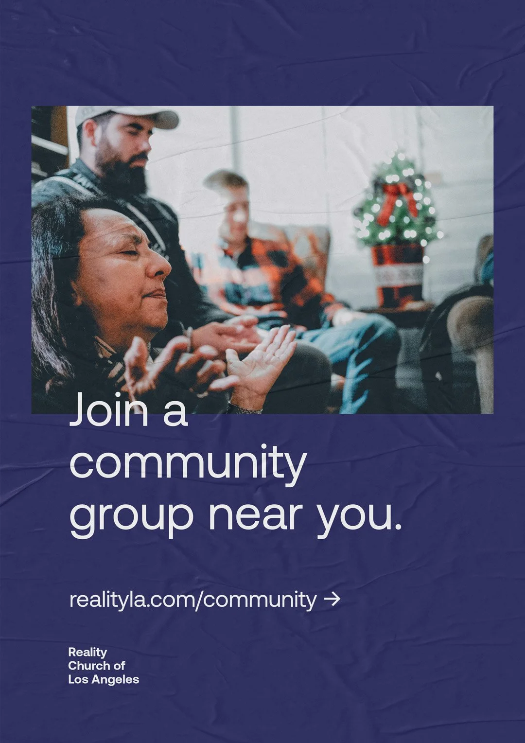 A promotional flyer showing people sitting together, with a Christmas tree in the background, encouraging joining a community group near you at the Realty Church of Los Angeles. The text says, 'Join a community group near you. realtyla.com/community'.