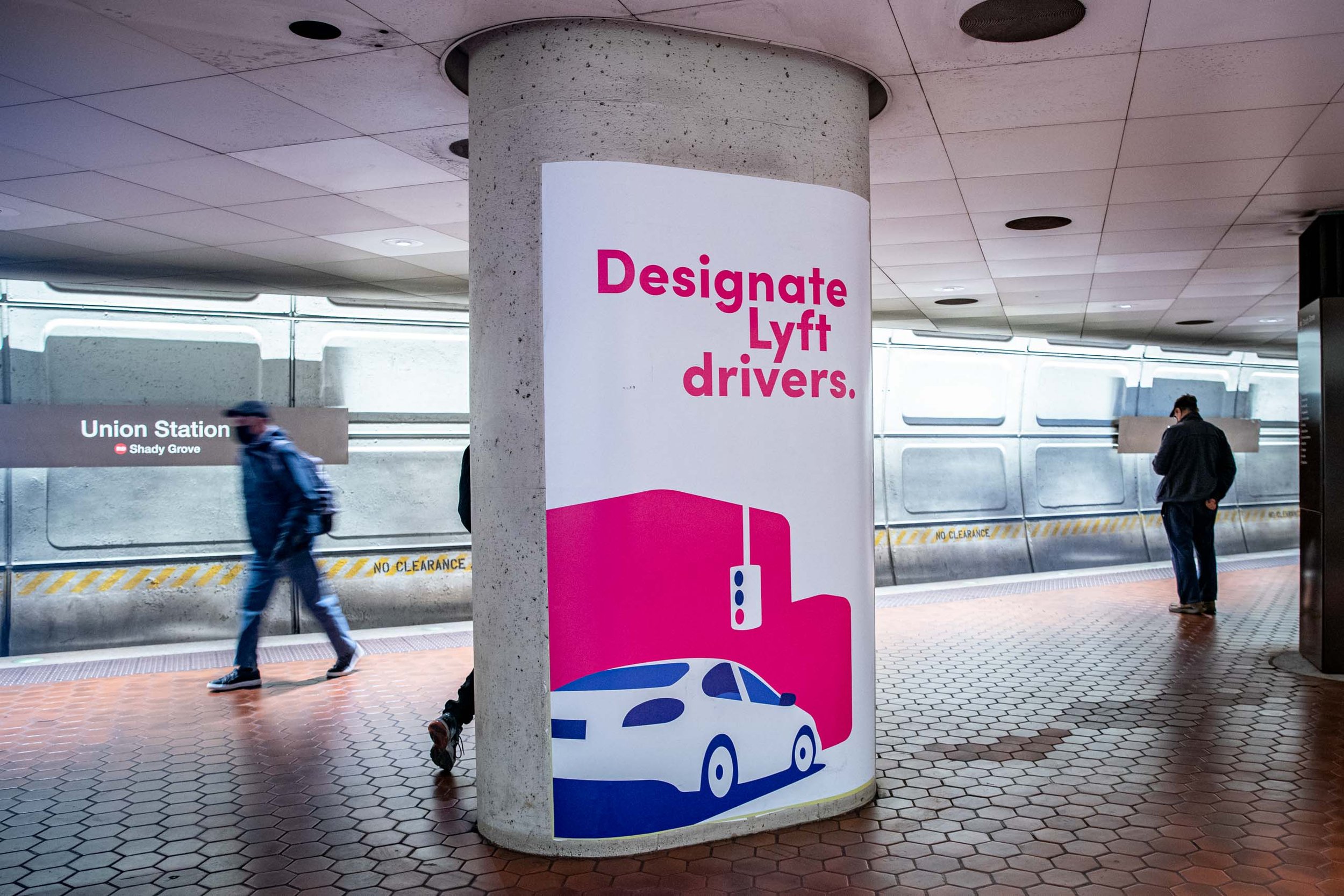 Sign in a subway station indicating the location of Lyft drivers and the designated area for lifts.