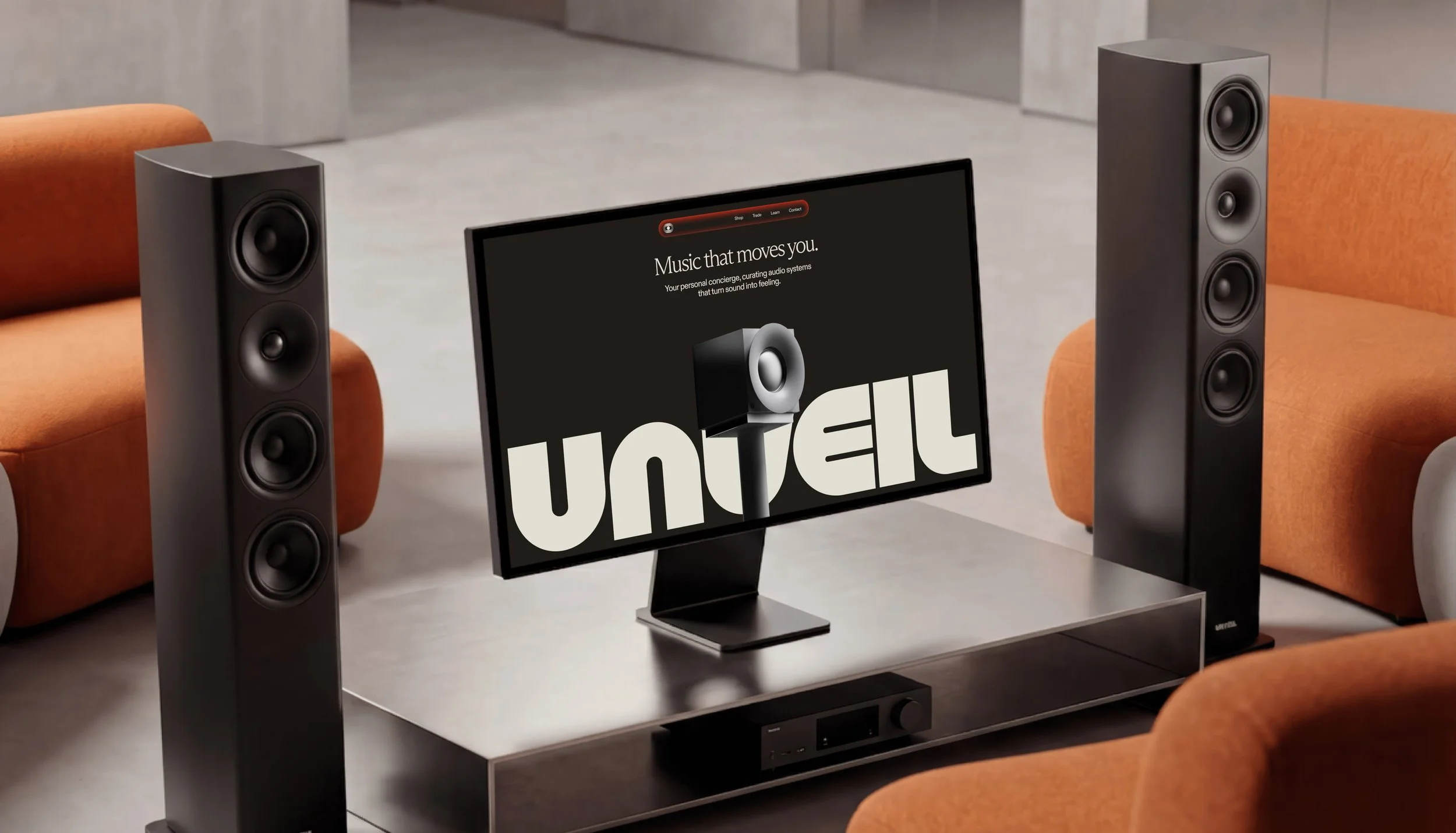 A modern home entertainment setup with two tall black speakers on either side of a flat-screen monitor displaying the words "Music that moves you" and a logo for Q Acoustic. The setup is on a black table in a room with orange chairs.