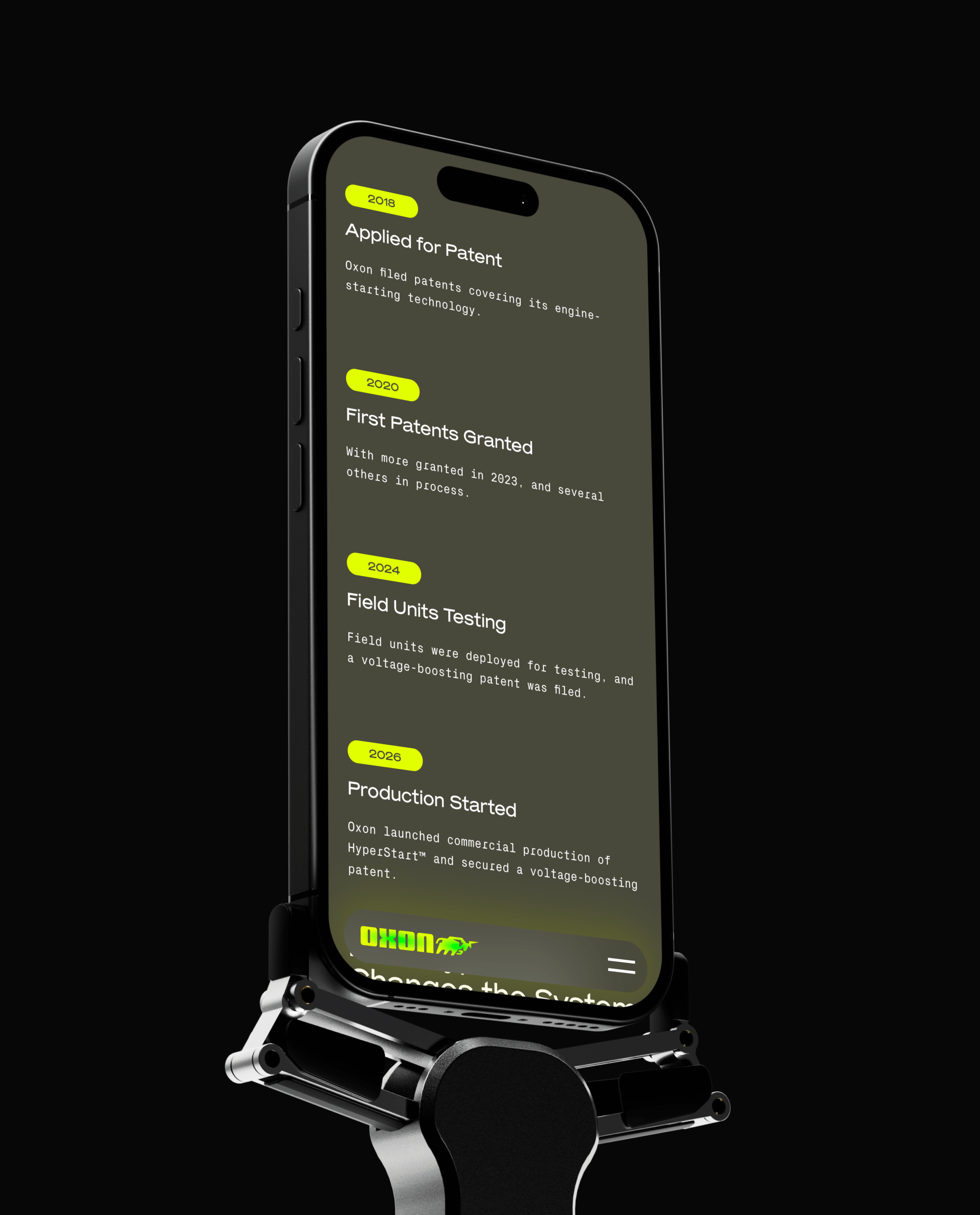 A futuristic smartphone mounted on a robotic stand, displaying text about patents filed and granted for Oxon, with highlighted years 2018, 2020, 2024, and 2026, against a black background.