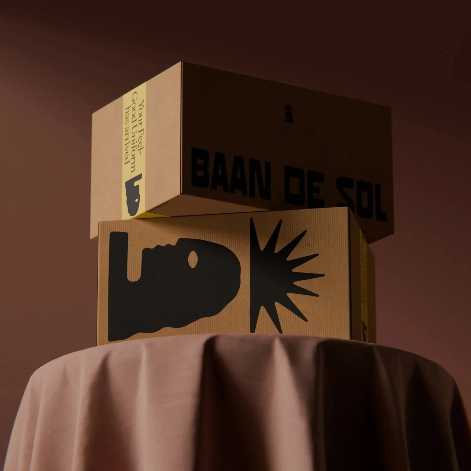 Stacked cardboard boxes with black and yellow warning labels, including a bomb icon and a sign saying 'You Feel-Good Uprising has arrived.'