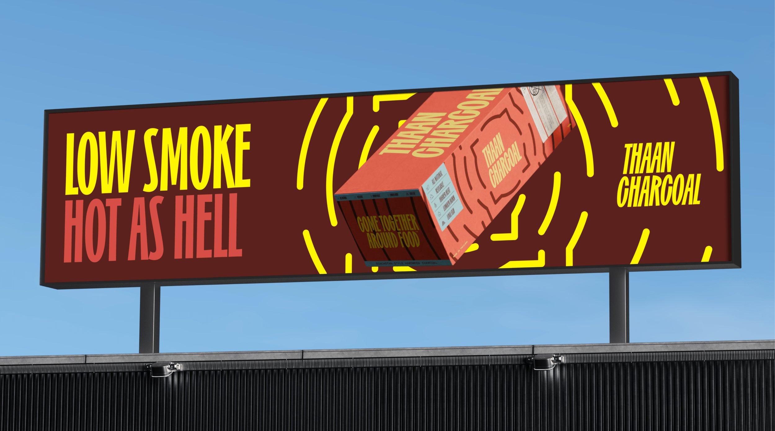 Billboard advertising Low Smoke Hot Ash Hell charcoal with a stylized image of a package of charcoal and the text "Come Together Around Food" and "Thank Charcoal"