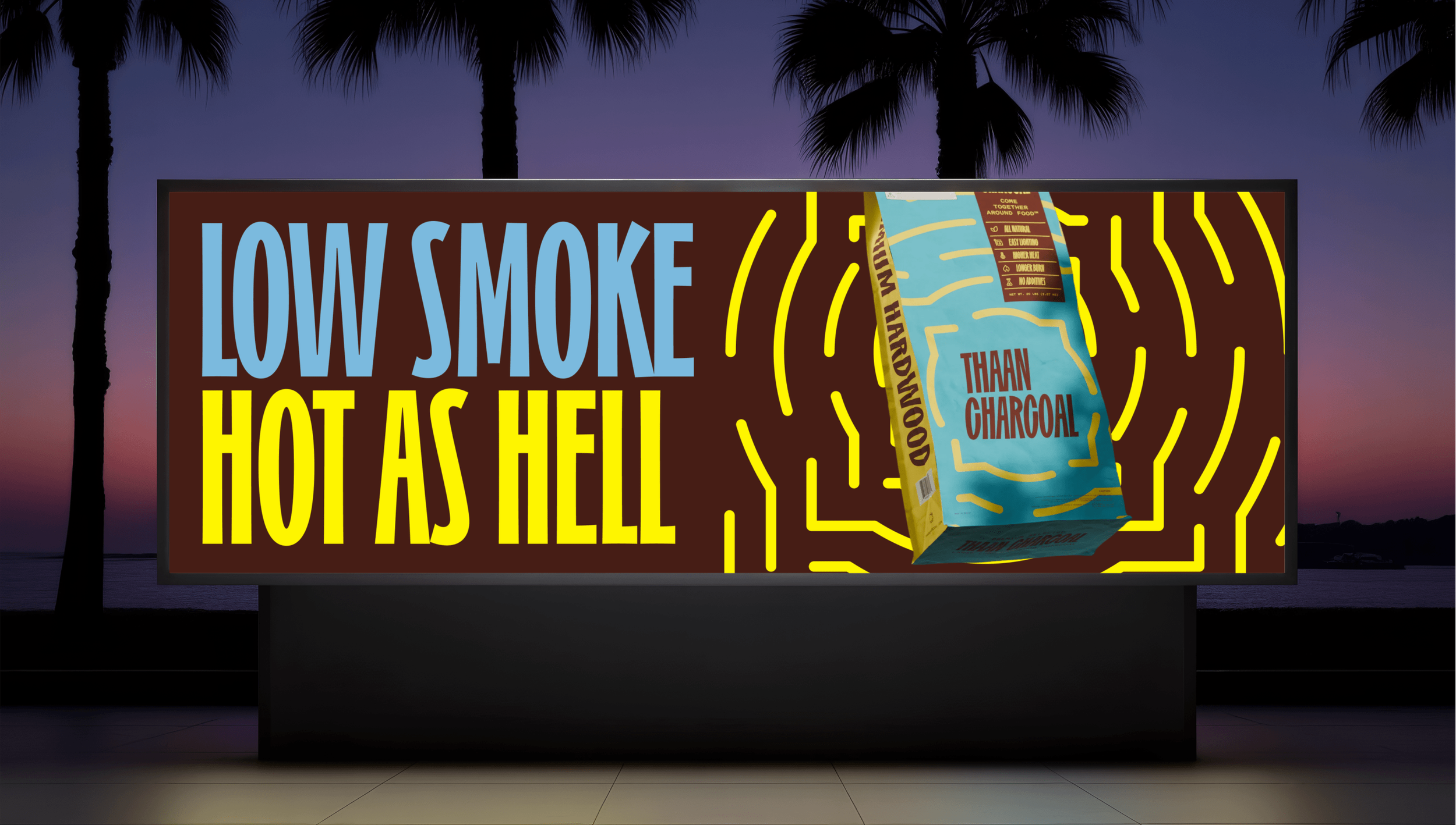 Billboard with the words 'LOW SMOKE HOT AS HELL' in large blue and yellow letters, featuring a bag of charcoal with illuminated yellow lines and a sunset with palm trees in the background.