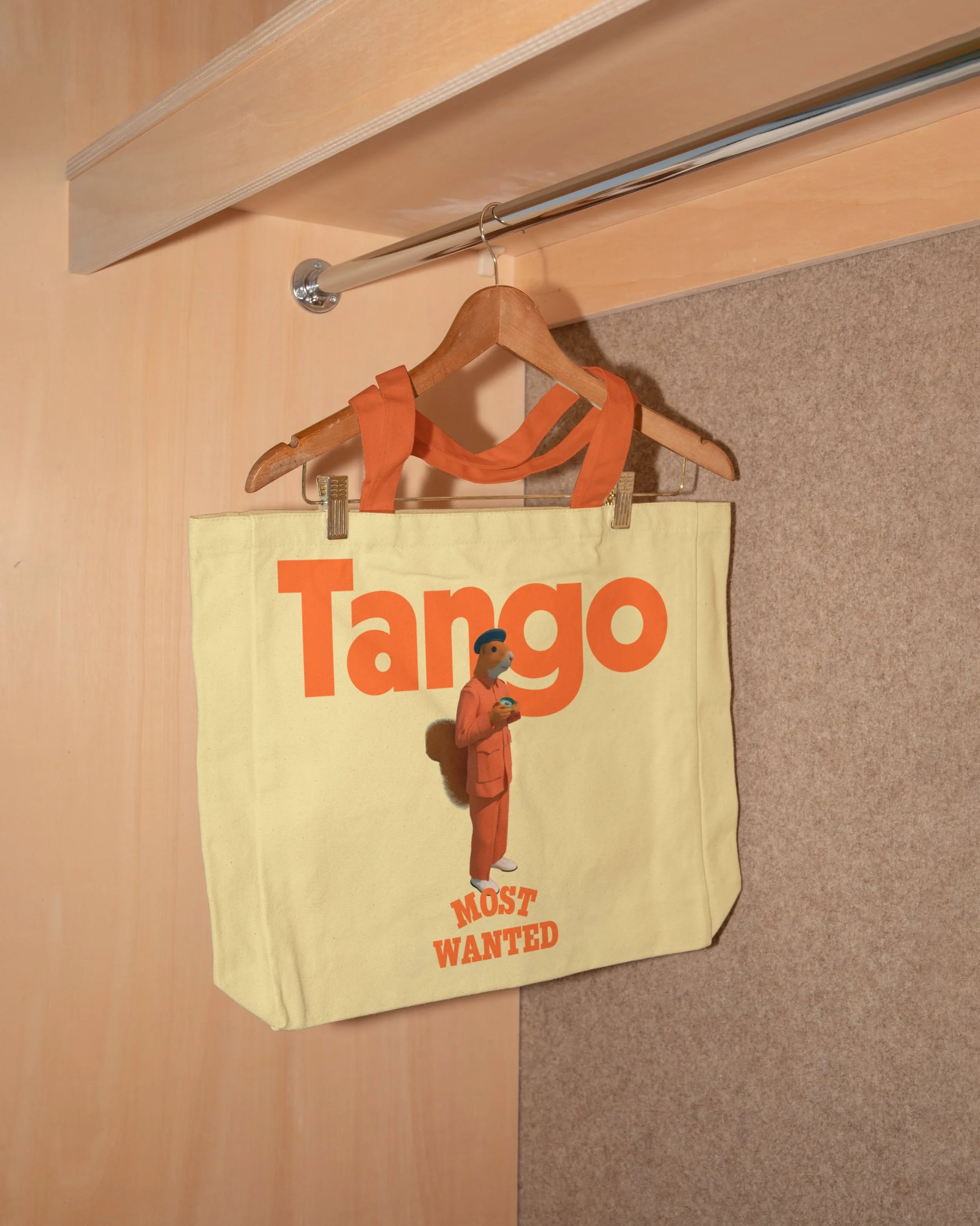 A yellow Targo banner with a cartoon figure in orange clothing holding a magnifying glass, and the text "MOST WANTED" in orange at the bottom, hangs on a wall with a beige carpet underneath.