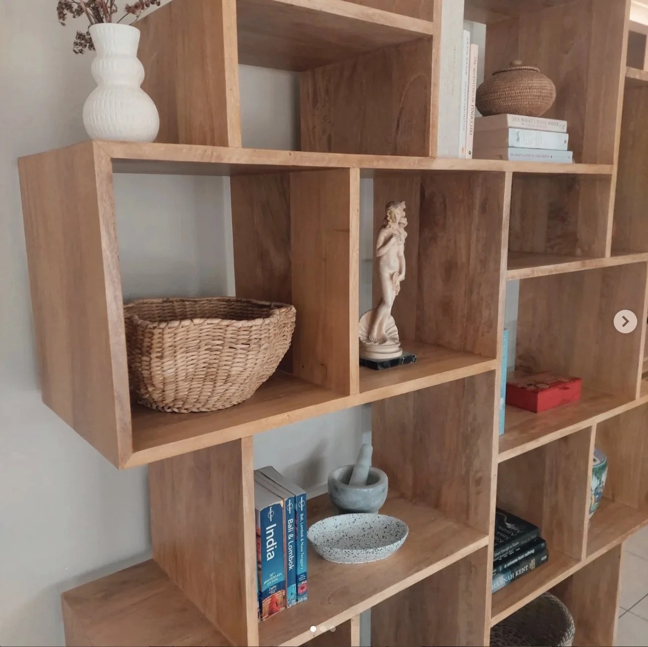 Custom timber shelving styled with natural decor, ceramic vases, and woven baskets — a curated balance of warmth, texture, and minimalism.