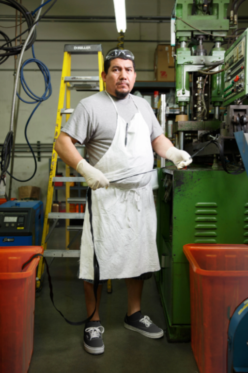 factory worker standing during shift representing how weight and prolonged standing can affect leg circulation