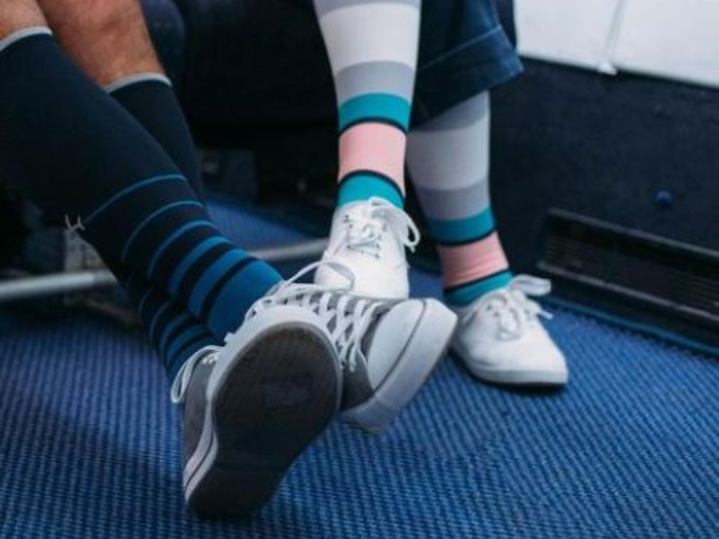 person sitting during long travel representing how immobility can slow leg circulation and increase blood clot risk