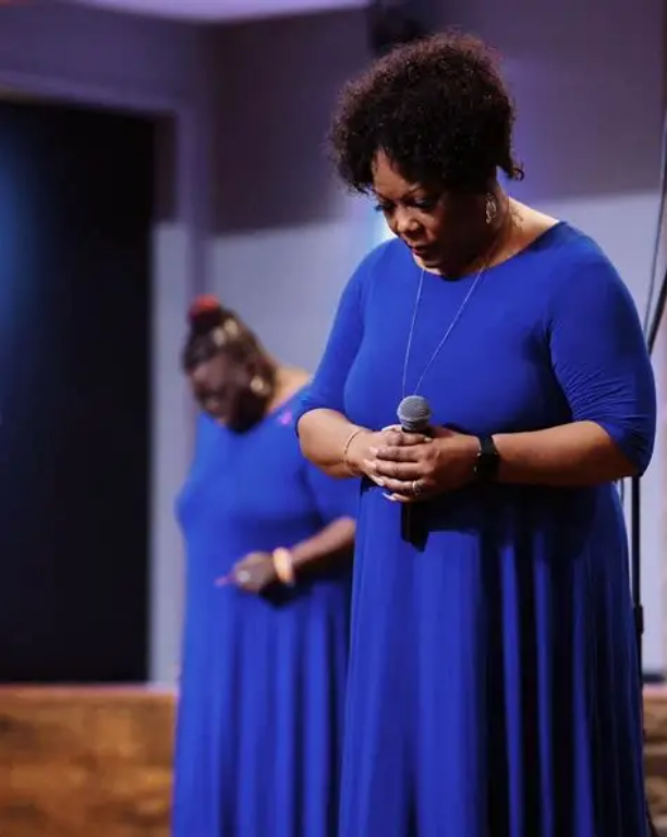 woman standing with tired posture representing leg heaviness and fatigue that may signal circulation problems