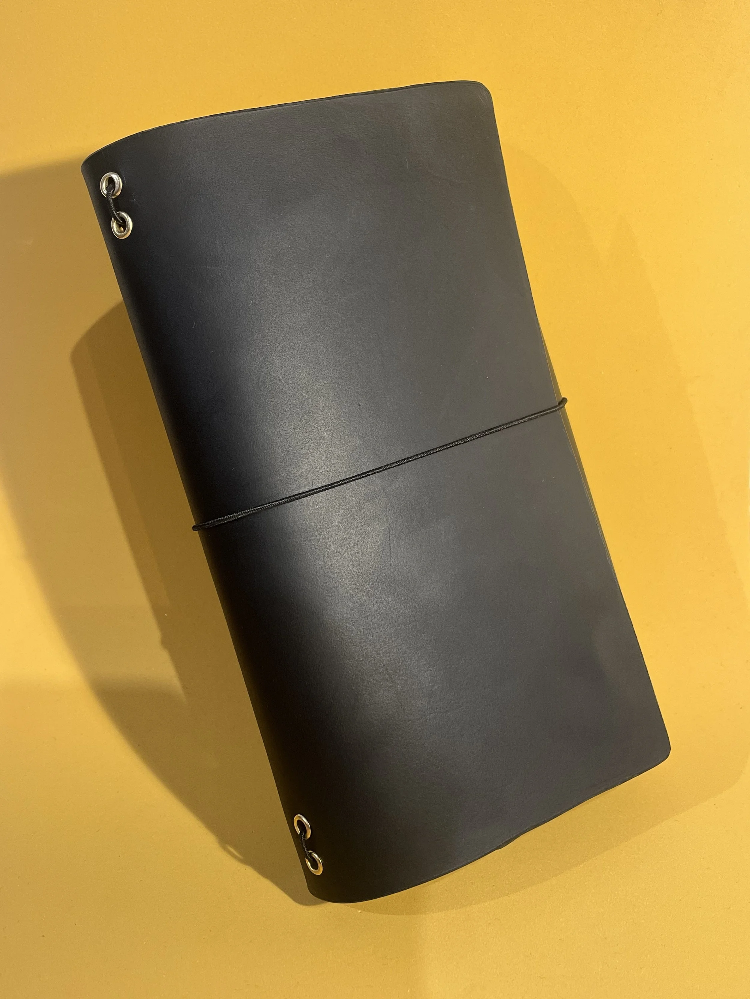 black leather journal orange background.jpg