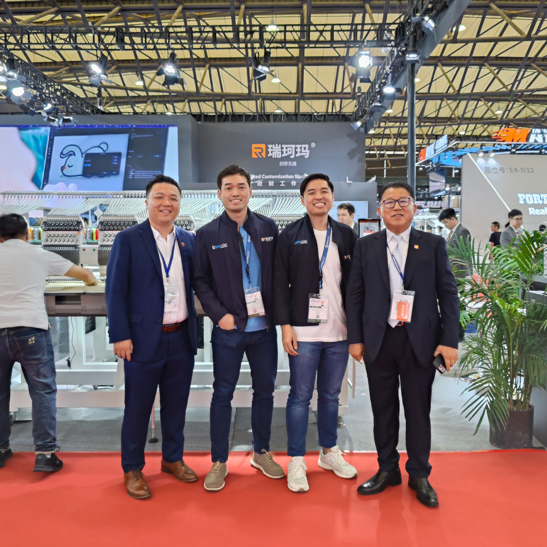 Bleuciel Automations representatives with Ricoma embroidery machines at an international textile machinery expo, highlighting their role as official Philippine distributor.