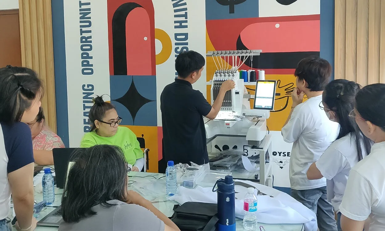 Bleuciel Automations Inc. guiding clients through production planning and embroidery machine operation during a hands-on consultation in the Philippines