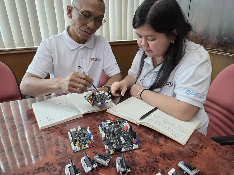 Bleuciel Automations technical team inspecting industrial sewing machine control boards for genuine spare parts support in the Philippines.