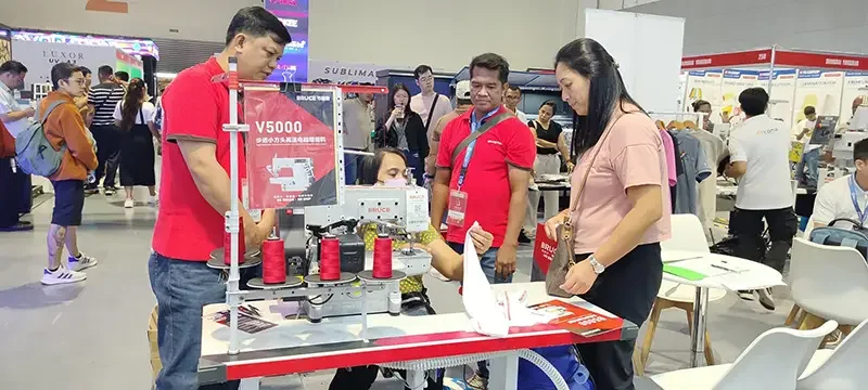 Bleuciel representatives providing on-site consultation and live demonstration of a BRUCE industrial sewing machine during a Philippine industry expo.