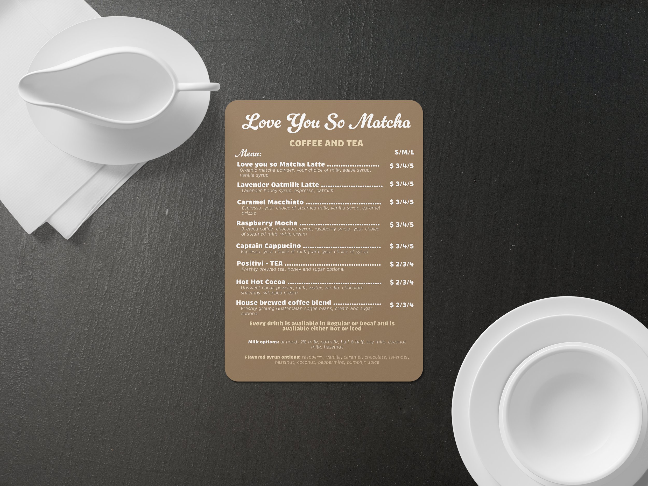 Coffee and tea menu on a dark table, with a white creamer pitcher, a cup, and a saucer.