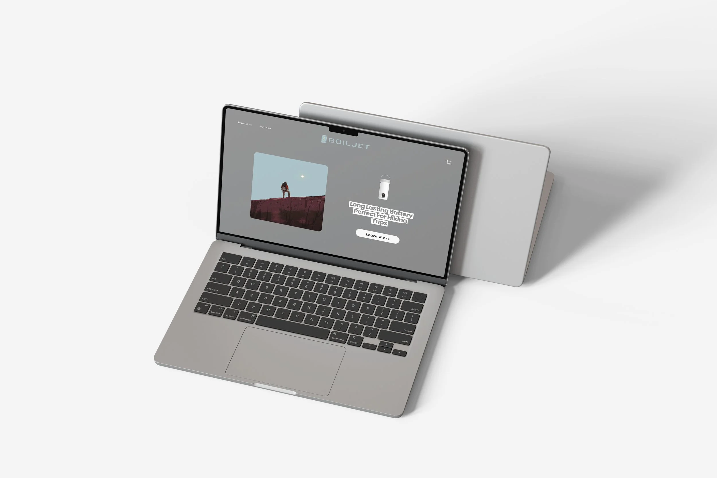 A silver laptop with black keyboard displaying an online store for portable batteries, with a graphic of a hiker against a mountain landscape and a product image of a white battery.