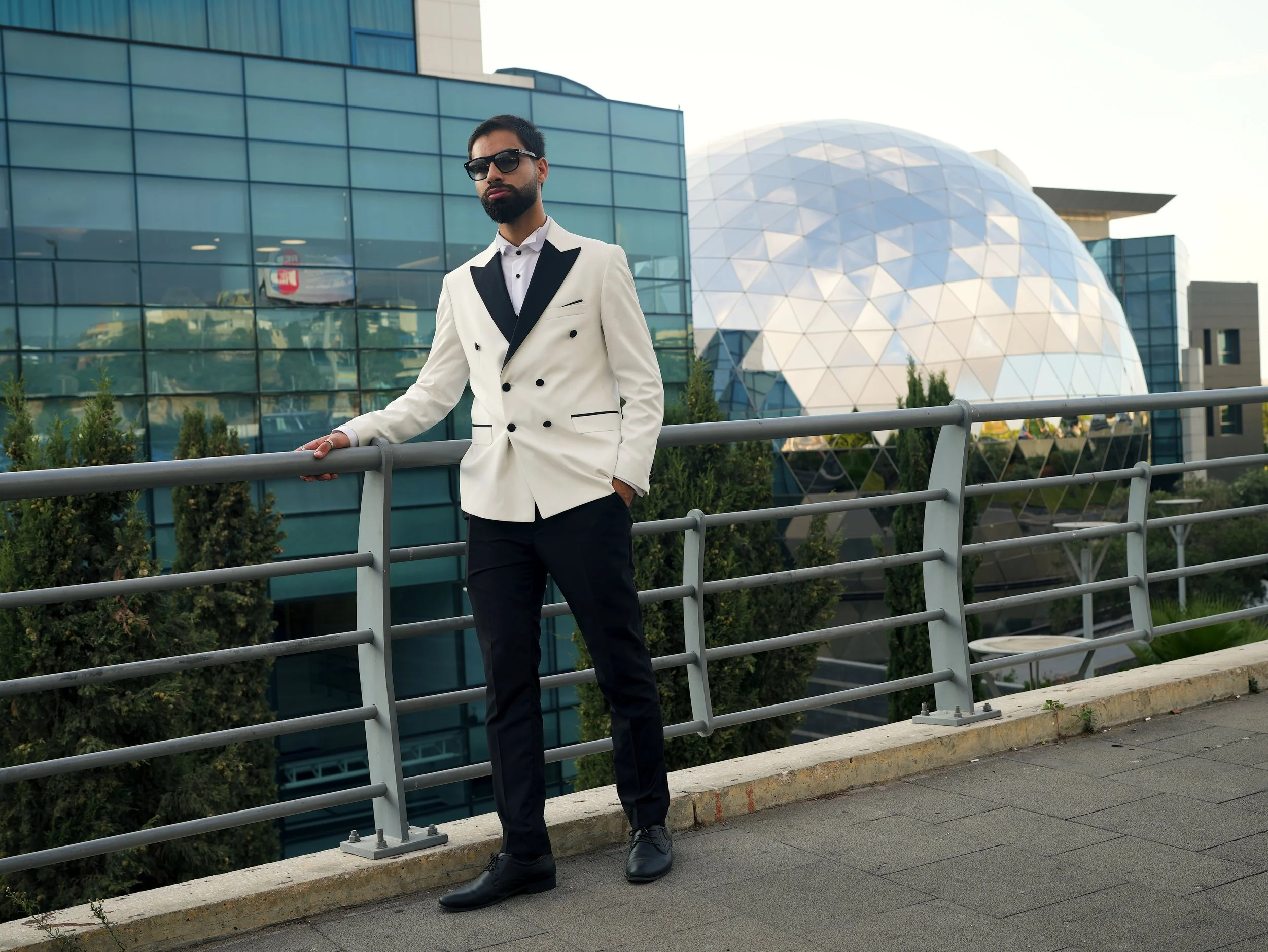 Founder of Nassar Creative Labs standing in a modern architectural setting, representing strategic growth and high-conversion digital systems.