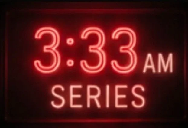 Neon clock displaying 3:33 AM with the word 'SERIES' below.